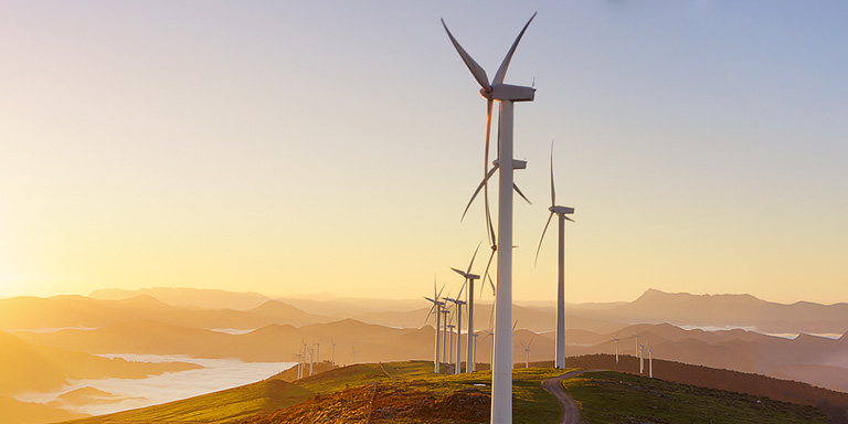 Image of sunrise and wind turbines