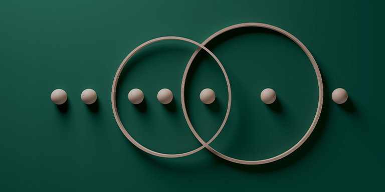 Dark green background showing a Venn Diagram of circles surrounding spheres.