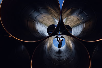 Expertise image of a worker checking pipes