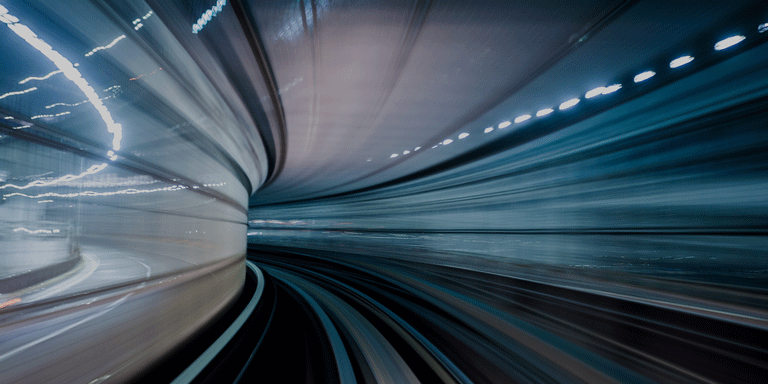 Mergers and acquisitions report banner of a train tunnel at speed