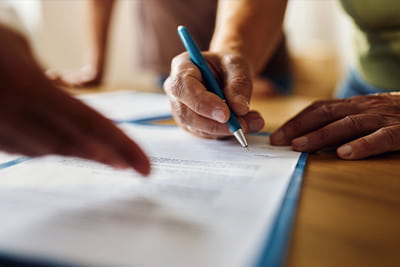 Probate image of a person signing a contract