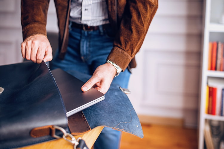 Next generation planning image of a person sliding a laptop into a bag