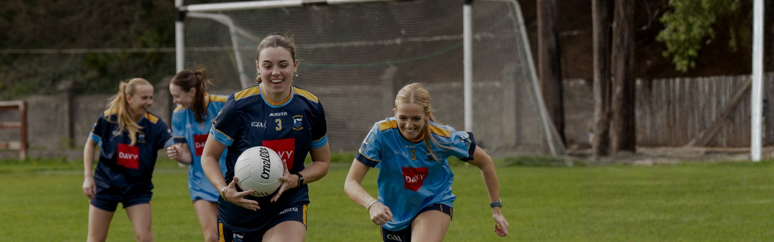 Local sponsorships banner image, girls playing GAA football