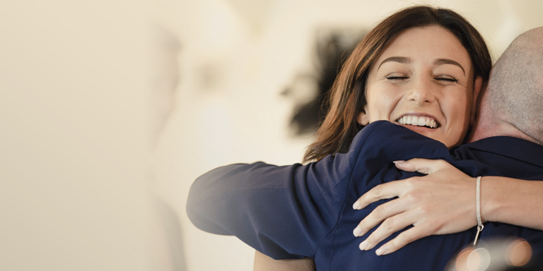 Bride hugging wedding guest