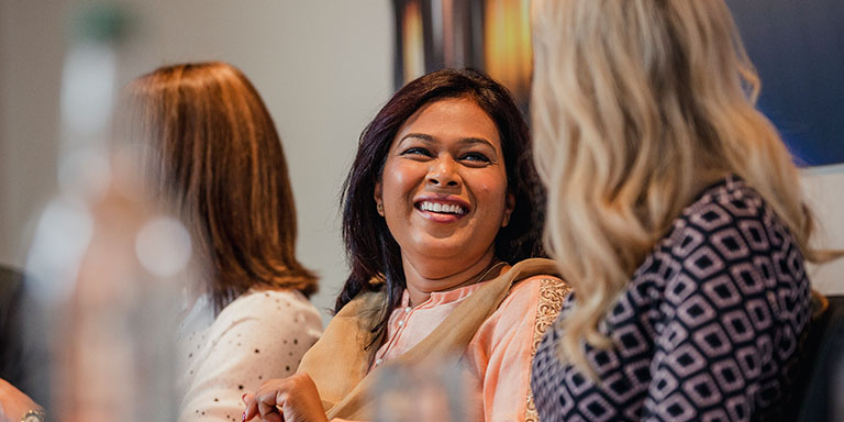 Women's reseach report image of happy people in conversation