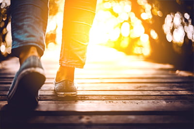 ESG social image of someone walking on some wooden decking