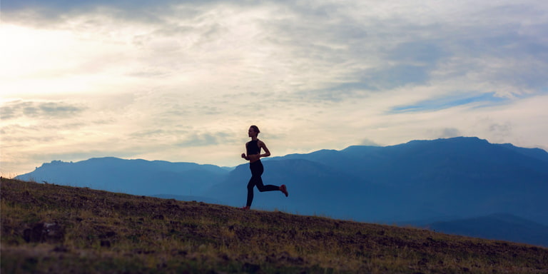 Sustainability image of a person running up a mountain