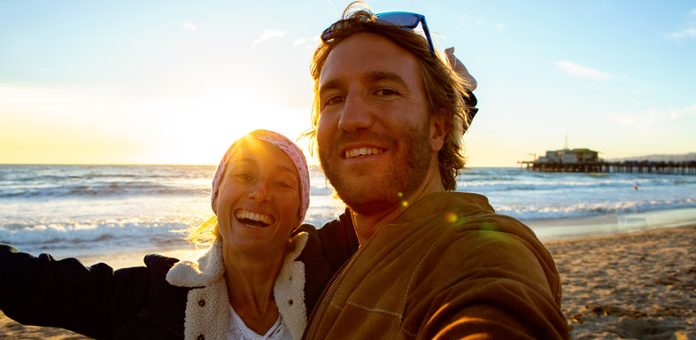 Financial planning image of a happy couple at the beach