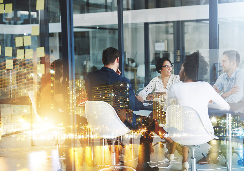 business people in meeting room with reflection of the city