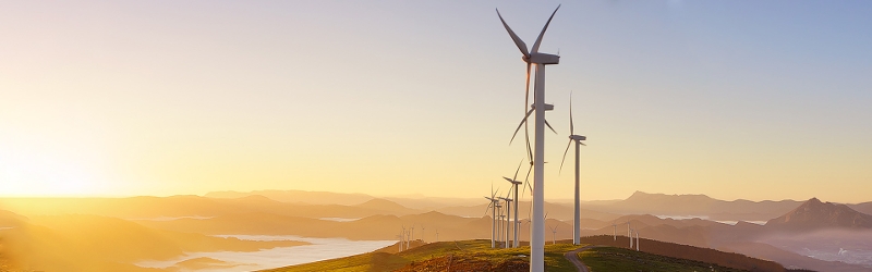 Image of sunrise and wind turbines