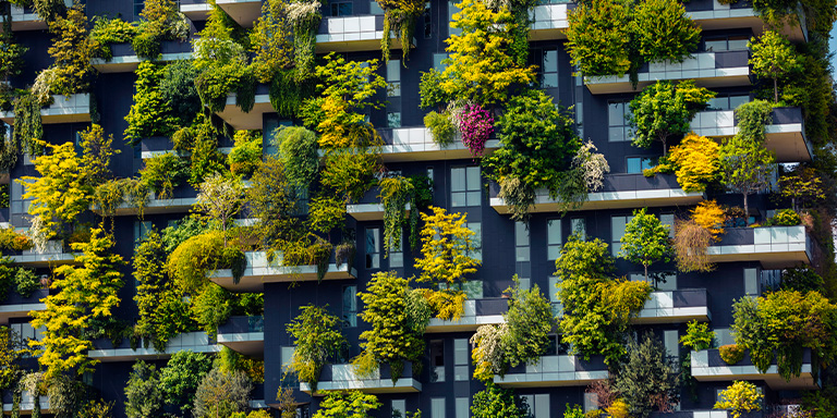 Apartment building with loads of plants on the balconies.