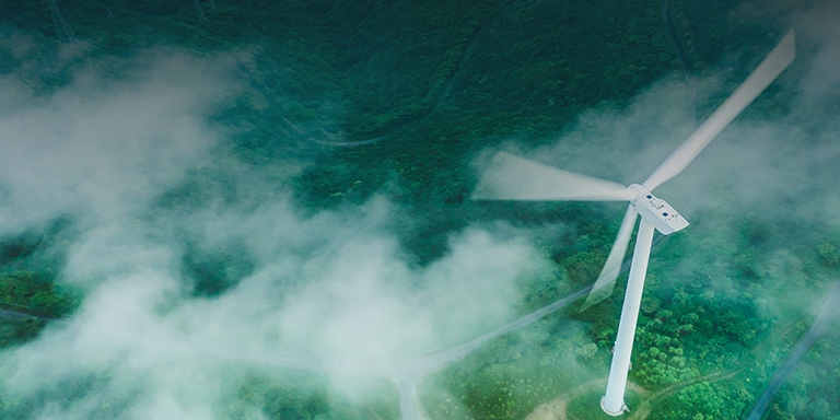 Image of a wind mill behind fog