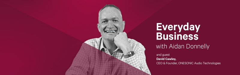 Red banner with man smiling in centre and text 