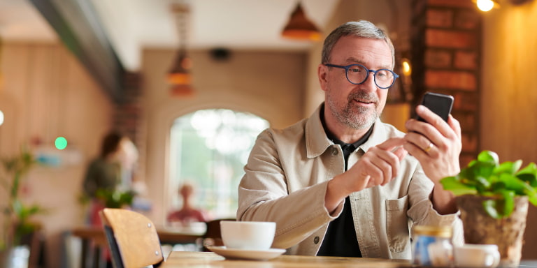 Corporate executive looking at his phone in a restaurant