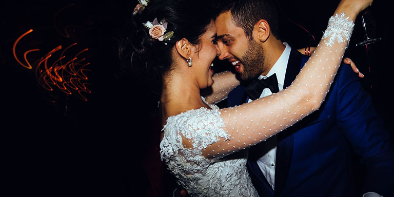 Image of happy bride and groom dancing