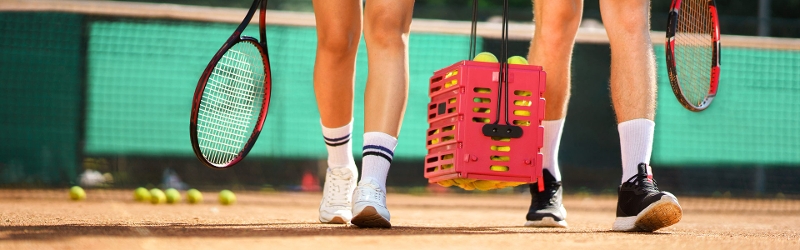 Man and woman walking onto tennis court