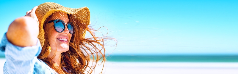 Living well image of a smiling woman in a sun hat