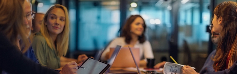 People sitting around a board room meeting
