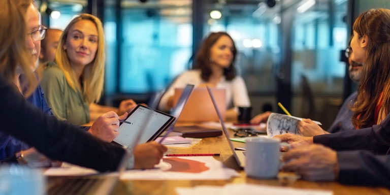 People sitting around a board room meeting