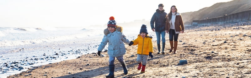 Image of family walking on the beach