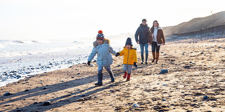 Image of family walking on the beach