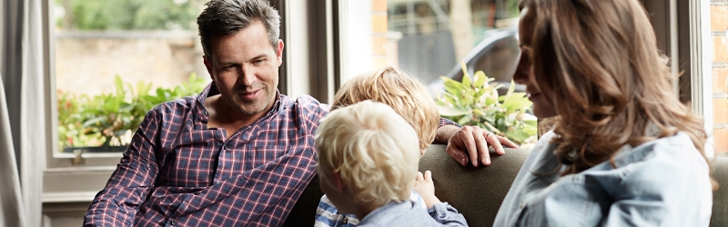 Discretionary trusts image of family sitting on a couch