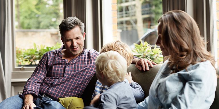 Discretionary trusts image of family sitting on a couch