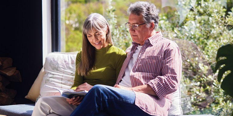 Image of happy couple reading document