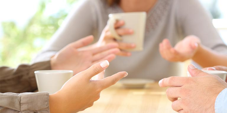 Group of individuals having a conversation over a coffee