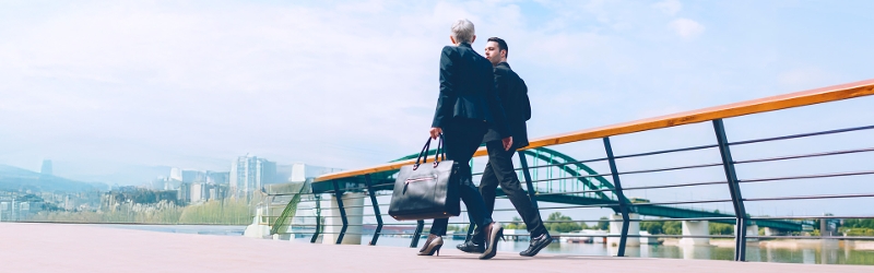 Image of business people walking and in discussion with each other