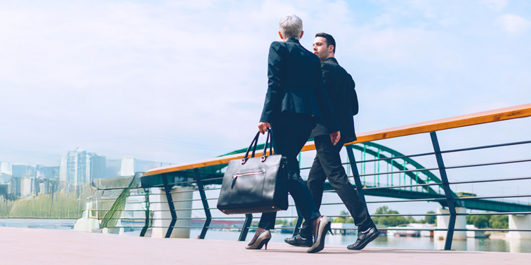 Image of business people walking and in discussion with each other