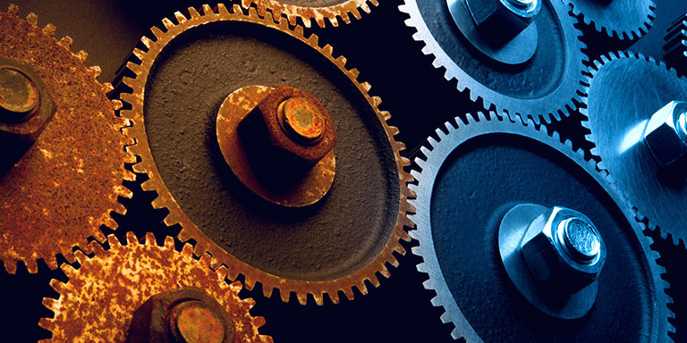 Traditional investment advice has had a bad decade. image shows rusty metals cogs next to shiny brand new cogs.
