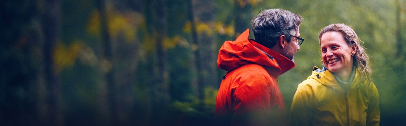 How to invest at Davy image of couple smiling at each other in forest