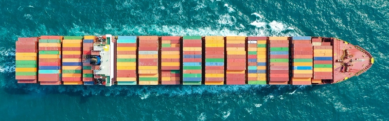 Aerial shot of a shipping container in the ocean
