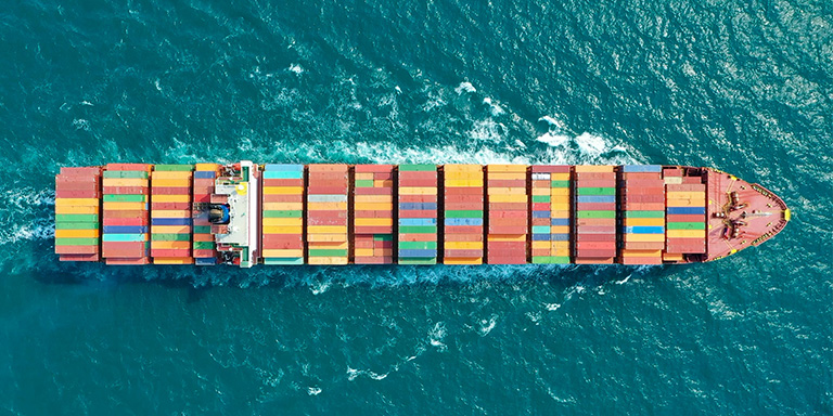 Aerial shot of a shipping container in the ocean