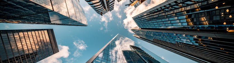 Looking directly up at the skyline of the financial district in central London