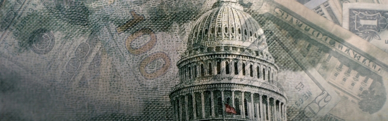 US Capitol building faded into a background of dollar bills.