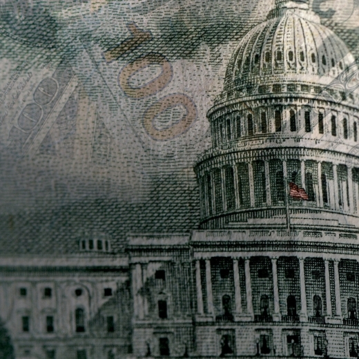 US Capitol building faded into a background of dollar bills.