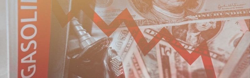 Gasoline pump with dollar bill and red arrow pointing downwards