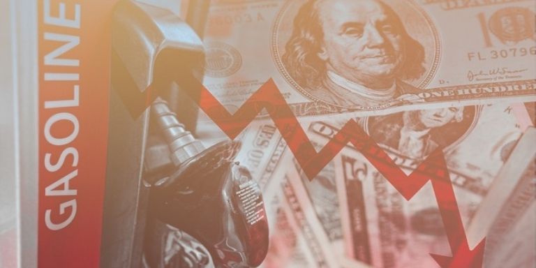 Gasoline pump with dollar bill and red arrow pointing downwards