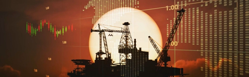 Oil rig surrounded by moving marking data depicting the turbulent stock market