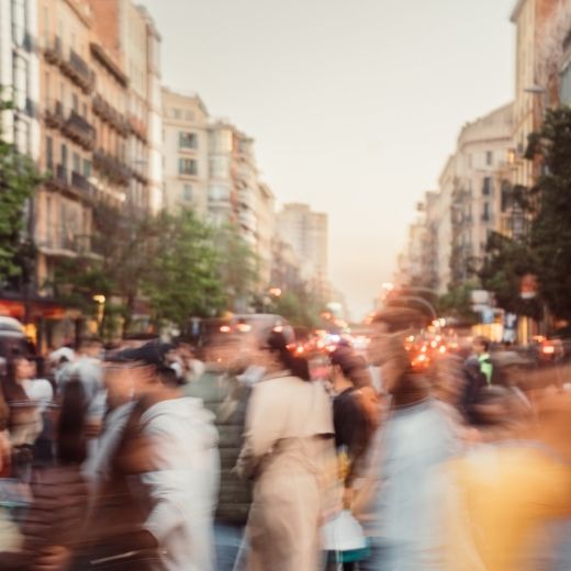 crowd of people walking across a busy road