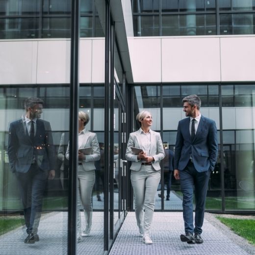 Two professionals working by office building