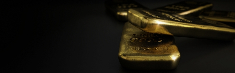 Gold bars on a black backdrop