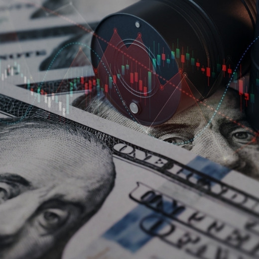 Image of oil barrels on top of a pile of $100 bills.