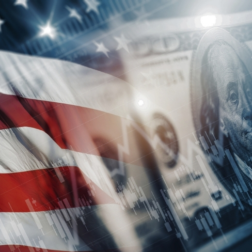US financial metrics faded onto a background of a flag and dollar bill