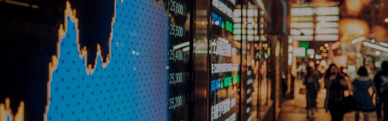 markets image of a chart though a window of a building